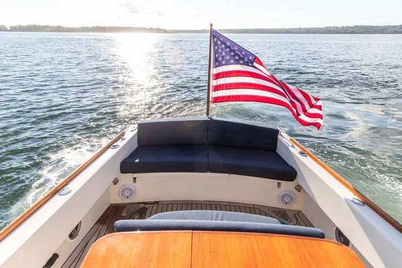 Wayfarer Yacht Photos Pics 2002 Hinckley Talaria 29C boat with American flag on open water.