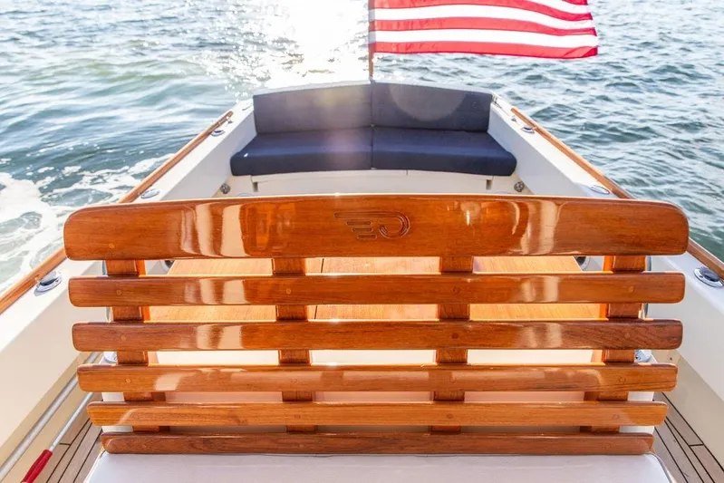 Wayfarer Yacht Photos Pics 2002 Hinckley Talaria 29C boat with wooden seating and American flag on water.