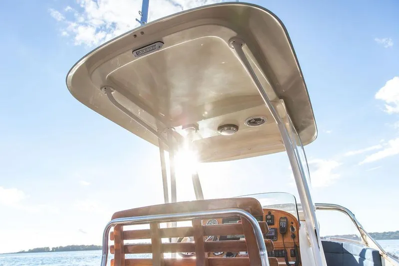 Wayfarer Yacht Photos Pics 2002 Hinckley Talaria 29C boat helm with sunlit canopy and clear blue sky.