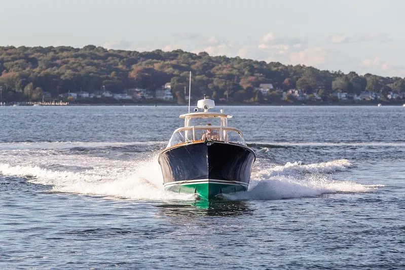 Wayfarer Yacht Photos Pics 2002 Hinckley Talaria 29C cruising on a scenic lake with forested shoreline.