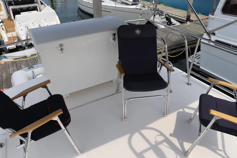 Emilie B Yacht Photos Pics Deck seating area on a 2003 American Tug 34, featuring comfortable chairs and storage.