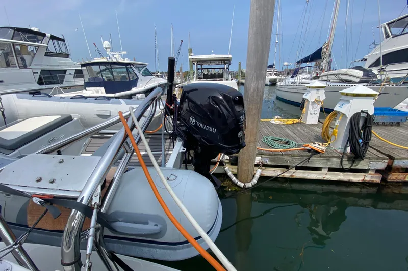 Emilie B Yacht Photos Pics 2003 American Tug 34 docked with Tohatsu outboard motor, surrounded by other boats.