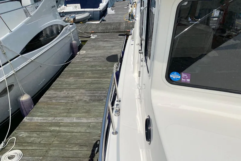 Emilie B Yacht Photos Pics American Tug 34 (2003) docked beside another boat at a marina.