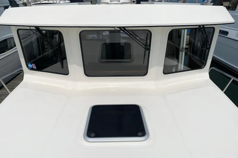 Emilie B Yacht Photos Pics 2003 American Tug 34 boat with large windows and deck hatch.