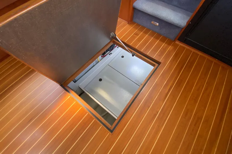 Emilie B Yacht Photos Pics Engine compartment access on 2003 American Tug 34 with wooden flooring.