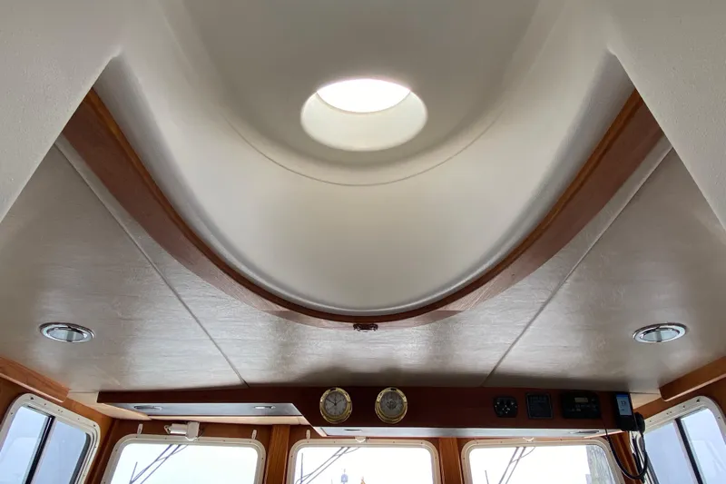 Emilie B Yacht Photos Pics Interior view of 2003 American Tug 34 with skylight and wooden accents.