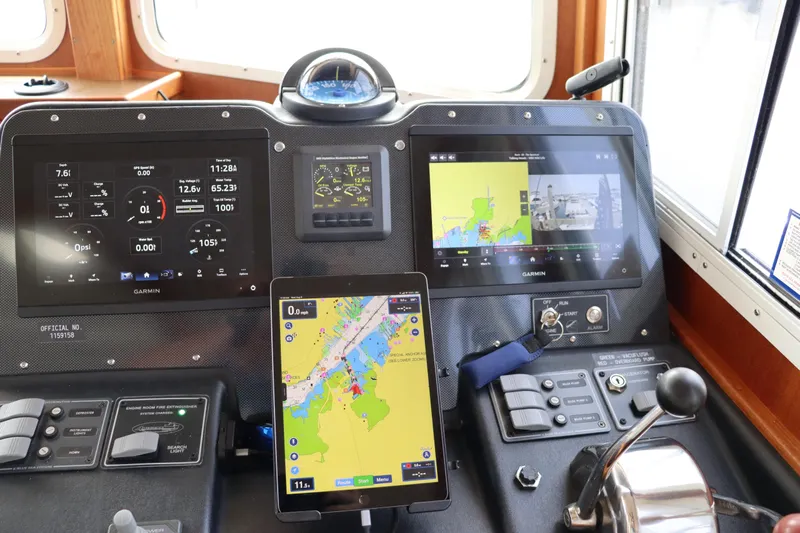 Emilie B Yacht Photos Pics Control panel of a 2003 American Tug 34 with Garmin navigation displays.