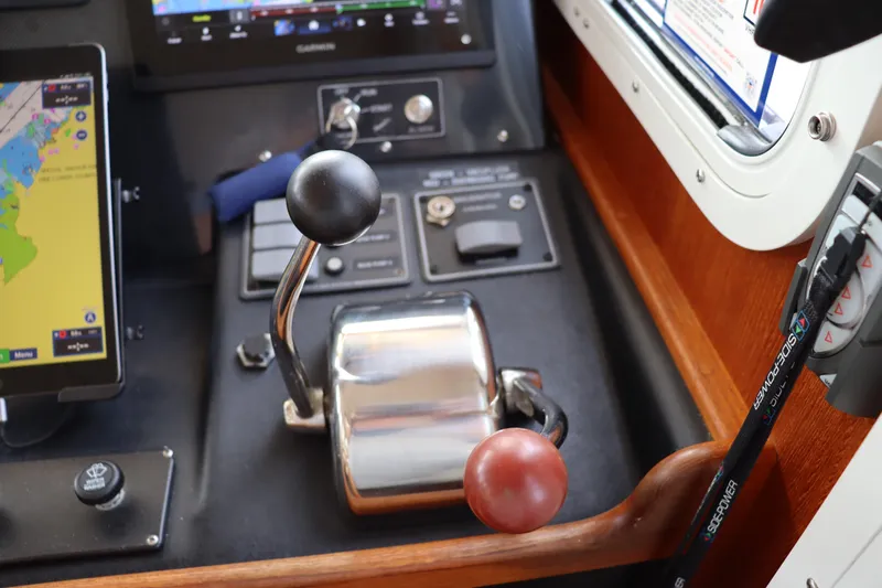 Emilie B Yacht Photos Pics Control panel of a 2003 American Tug 34 with navigation and throttle levers.