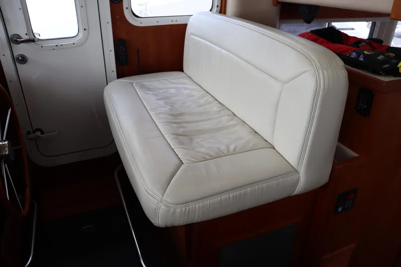 Emilie B Yacht Photos Pics Interior of a 2003 American Tug 34, featuring a white leather bench seat.
