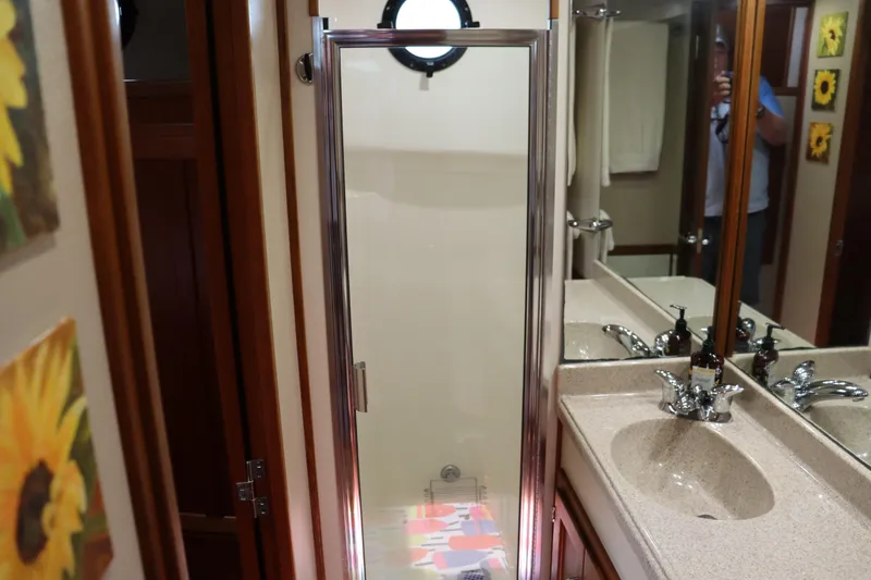 Emilie B Yacht Photos Pics Bathroom interior of a 2003 American Tug 34, featuring a shower and sink.