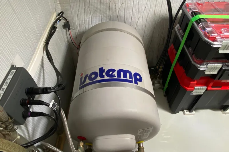 Emilie B Yacht Photos Pics Isotemp water heater in 2003 American Tug 34 engine room, with control unit and storage boxes.