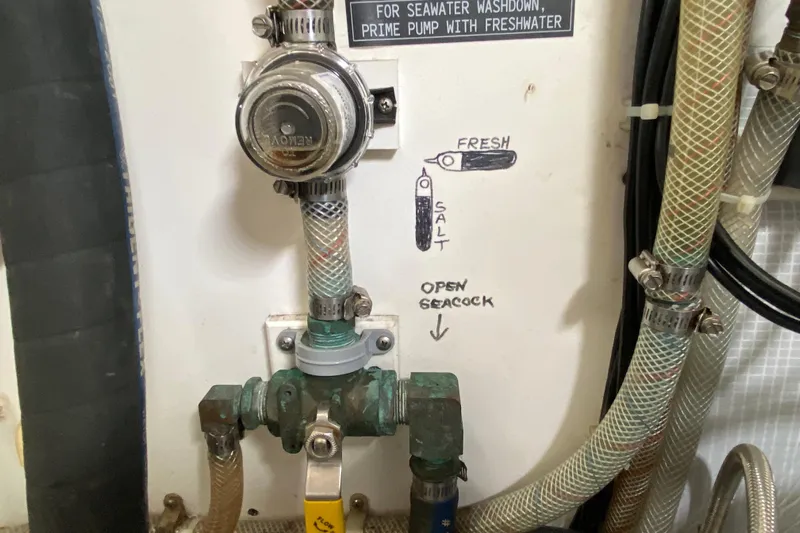 Emilie B Yacht Photos Pics Seawater washdown system on a 2003 American Tug 34, featuring labeled valves and hoses.
