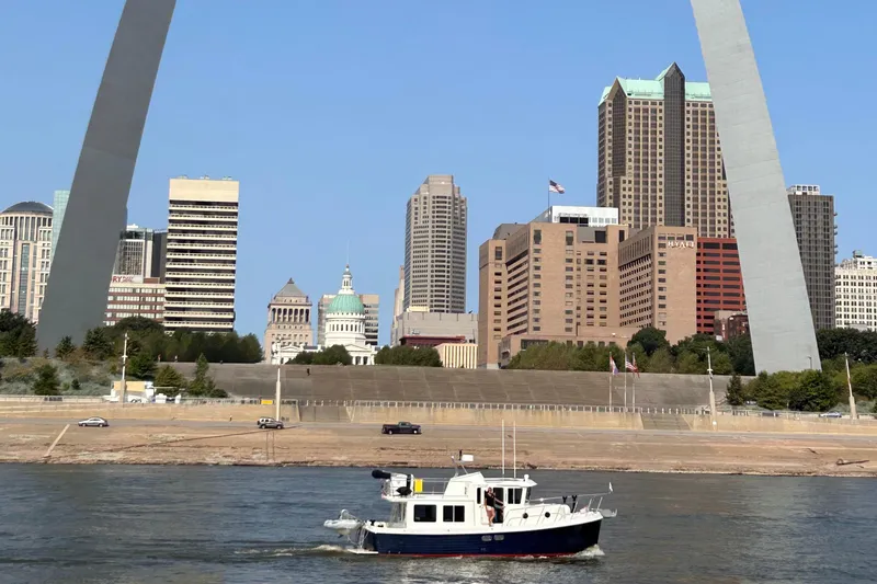 Emilie B Yacht Photos Pics American Tug 34 (2003) cruising near St. Louis Gateway Arch, city skyline in background.