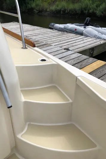  Yacht Photos Pics Steps on a 2009 Sabre 40 Sedan yacht near a wooden dock.