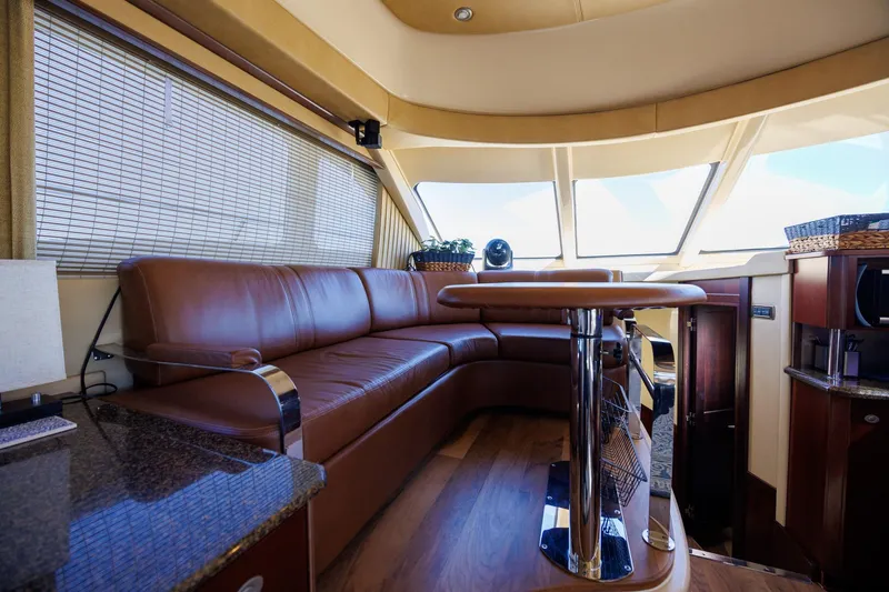 Zoe Grace Yacht Photos Pics Luxurious interior of 2006 Sea Ray 52 Sedan Bridge with leather seating and panoramic windows.