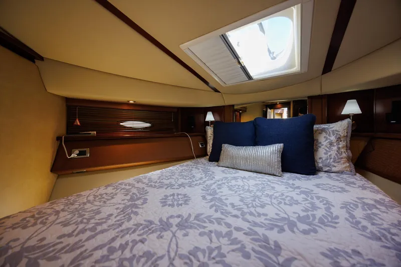 Zoe Grace Yacht Photos Pics Luxurious bedroom interior of 2006 Sea Ray 52 Sedan Bridge yacht with skylight and elegant bedding.