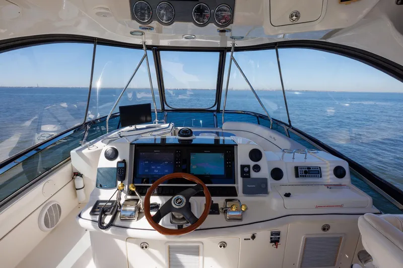 Zoe Grace Yacht Photos Pics 2006 Sea Ray 52 Sedan Bridge helm with ocean view, featuring modern navigation equipment.