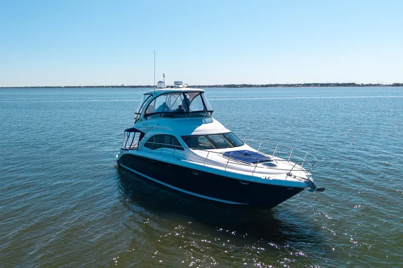 Zoe Grace Yacht Photos Pics 2006 Sea Ray 52 Sedan Bridge yacht on calm waters under clear sky.