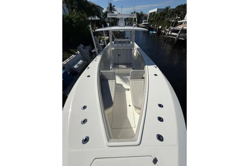  Yacht Photos Pics 2022 SeaVee 370Z boat with spacious deck and modern design, docked in a marina.