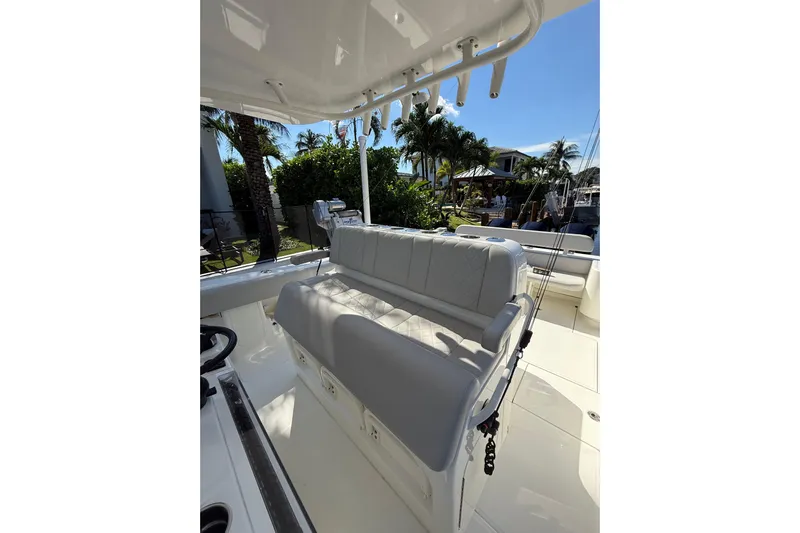  Yacht Photos Pics 2022 SeaVee 370Z boat interior with cushioned seating and fishing rod holders.