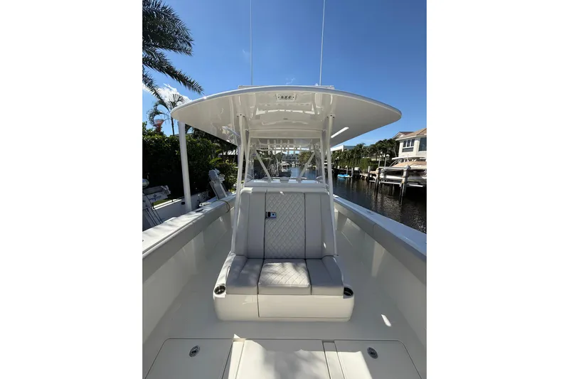  Yacht Photos Pics 2022 SeaVee 370Z boat interior with seating, docked by waterfront homes.