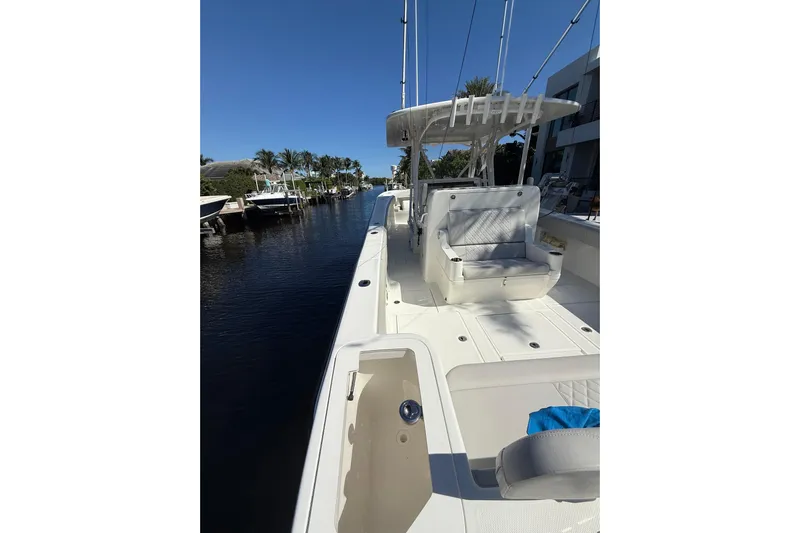  Yacht Photos Pics 2022 SeaVee 370Z boat docked, featuring spacious deck and seating under clear blue sky.