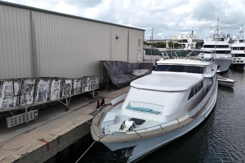  Yacht Photos Pics 1990 Denison Pilothouse Cockpit Motoryacht docked at marina, overcast sky.
