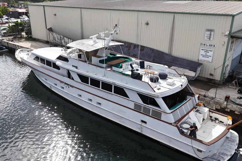  Yacht Photos Pics 1990 Denison Pilothouse Cockpit Motoryacht docked near a warehouse, aerial view.