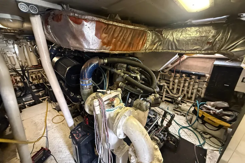  Yacht Photos Pics Engine room of a 1990 Denison Pilothouse Cockpit Motoryacht, showcasing complex machinery.