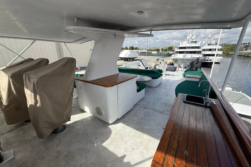  Yacht Photos Pics 1990 Denison Pilothouse Cockpit Motoryacht deck with seating, sink, and covered equipment.