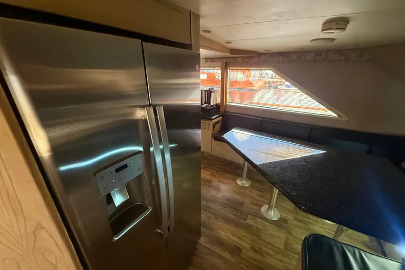  Yacht Photos Pics Interior of 1990 Denison Pilothouse Cockpit Motoryacht with modern kitchen and dining area.