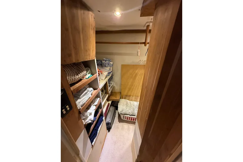  Yacht Photos Pics 1990 Denison Pilothouse Motoryacht interior with wooden shelves and cozy bedding.