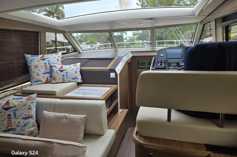 Green Eye Lady Yacht Photos Pics Interior of 2019 Greenline 40 yacht with nautical-themed cushions and modern helm.