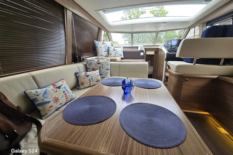 Green Eye Lady Yacht Photos Pics Interior of 2019 Greenline 40 yacht with nautical-themed cushions and modern decor.