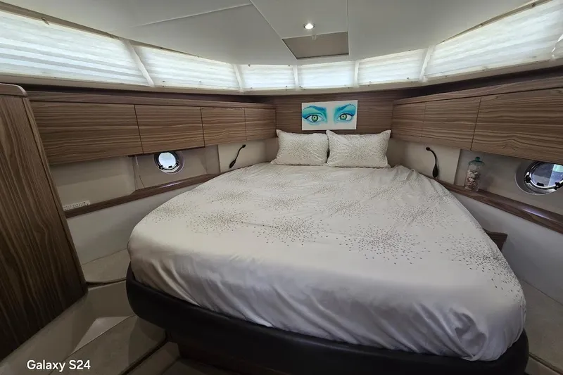 Green Eye Lady Yacht Photos Pics Luxurious bedroom interior of 2019 Greenline 40 yacht with elegant wood paneling.