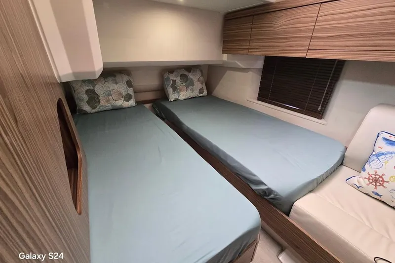 Green Eye Lady Yacht Photos Pics Interior cabin of 2019 Greenline 40 yacht with twin beds and wooden cabinetry.