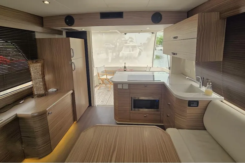 Green Eye Lady Yacht Photos Pics Luxurious interior of 2019 Greenline 40 yacht with modern kitchen and seating area.