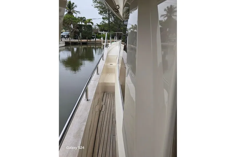 Green Eye Lady Yacht Photos Pics Side view of 2019 Greenline 40 yacht docked by a calm waterfront.