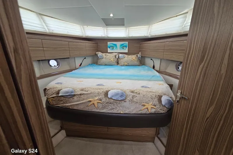 Green Eye Lady Yacht Photos Pics Luxurious cabin interior of 2019 Greenline 40 yacht with beach-themed bedding.