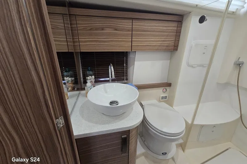 Green Eye Lady Yacht Photos Pics Luxurious bathroom in 2019 Greenline 40 yacht with modern fixtures and wood accents.