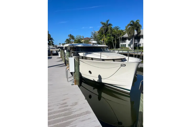 Green Eye Lady Yacht Photos Pics 2019 Greenline 40 yacht docked at a marina under clear blue skies.