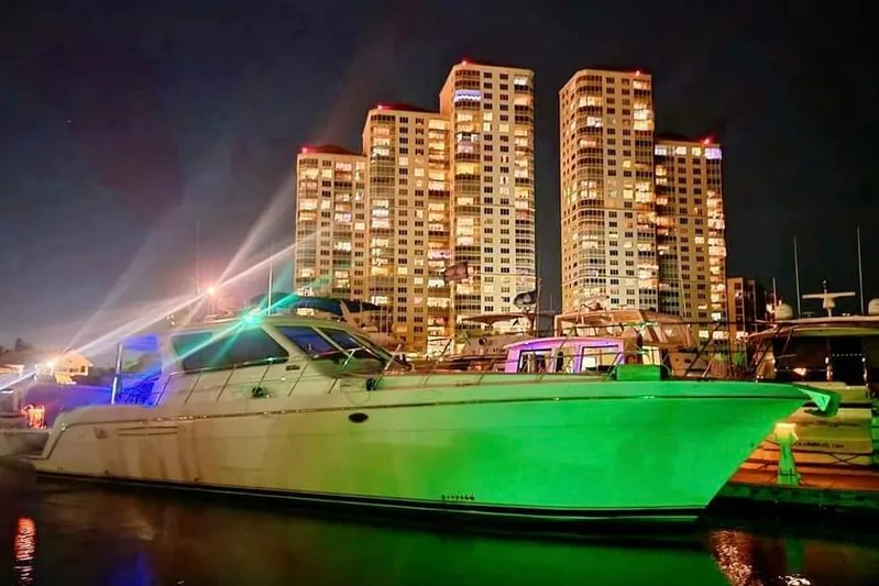  Yacht Photos Pics Luxury yacht Navigator Californian Veneti 2003 docked at night with illuminated cityscape backdrop.