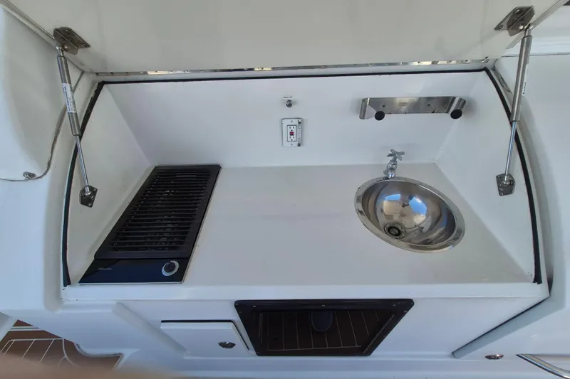  Yacht Photos Pics Outdoor kitchenette on 2003 Navigator Californian Veneti yacht with sink and grill.