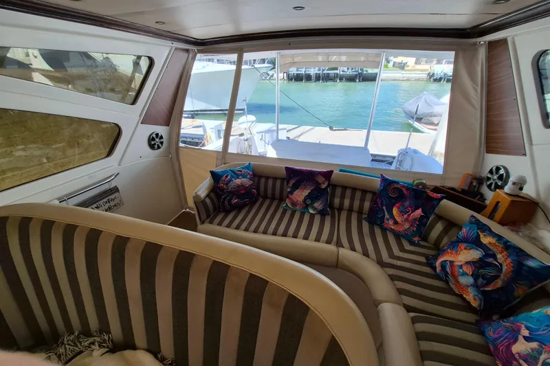  Yacht Photos Pics Interior of 2003 Navigator Californian Veneti yacht with striped seating and colorful pillows.