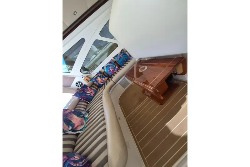  Yacht Photos Pics Interior of 2003 Navigator Californian Veneti yacht with striped seating and colorful cushions.