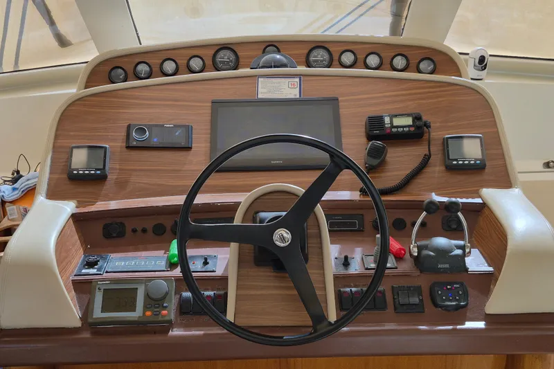  Yacht Photos Pics 2003 Navigator Californian Veneti yacht helm with steering wheel and navigation controls.