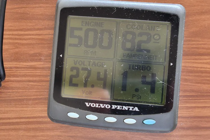  Yacht Photos Pics Volvo Penta engine display showing RPM, coolant temperature, voltage, and turbo PSI on wood surface.