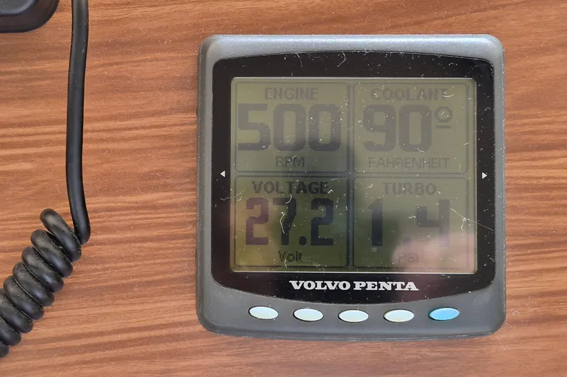  Yacht Photos Pics Volvo Penta engine display showing RPM, coolant temperature, voltage, and turbo PSI on wood surface.