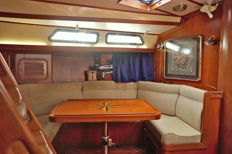 Oleta Yacht Photos Pics Cozy interior of 2005 Tayana 48 yacht with elegant wood finish and comfortable seating.
