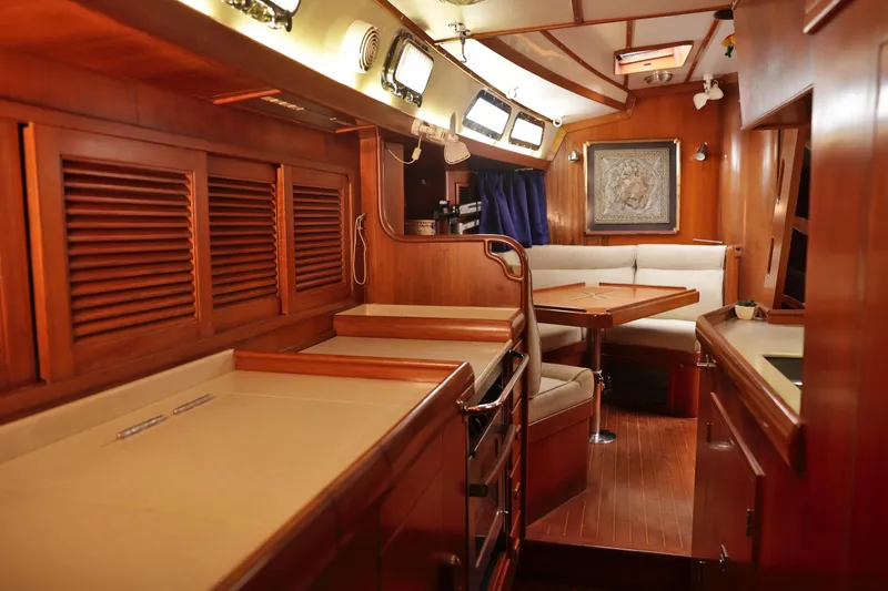 Oleta Yacht Photos Pics Luxurious 2005 Tayana 48 yacht interior with wooden finishes and cozy seating area.